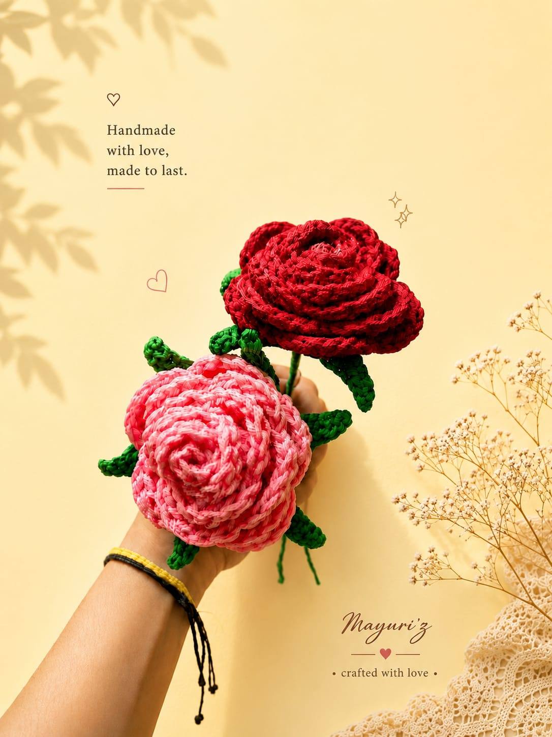 Two handmade crochet roses, one red and one pink, held in a hand